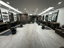 It is a barber shop with a lot of chairs and mirrors.