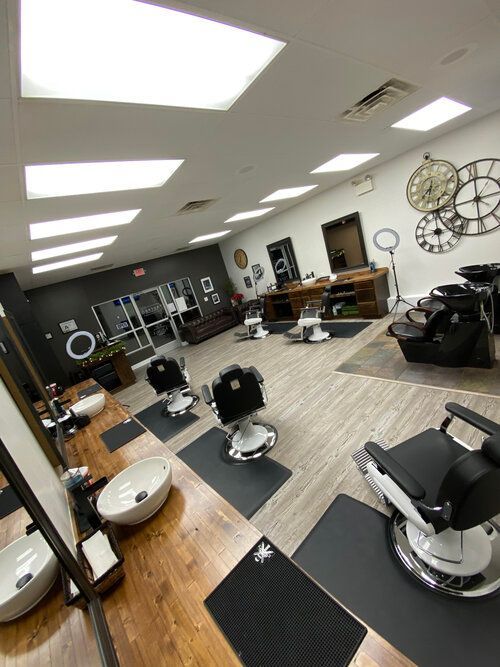 A barber shop with a lot of chairs and sinks.