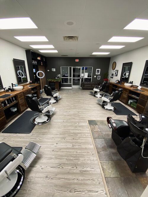 A barber shop with a lot of chairs and mirrors.