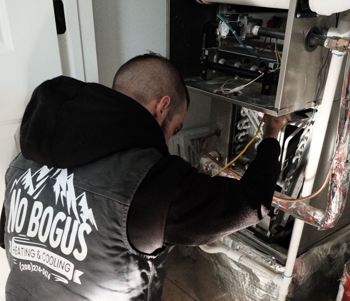 A man in a vest is working on a heating system.