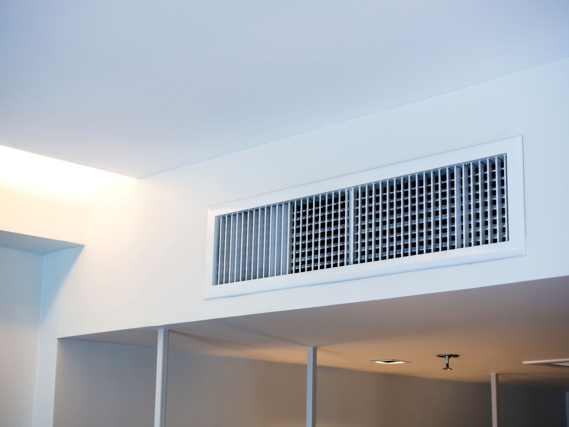 A room with a ceiling mounted air conditioner.