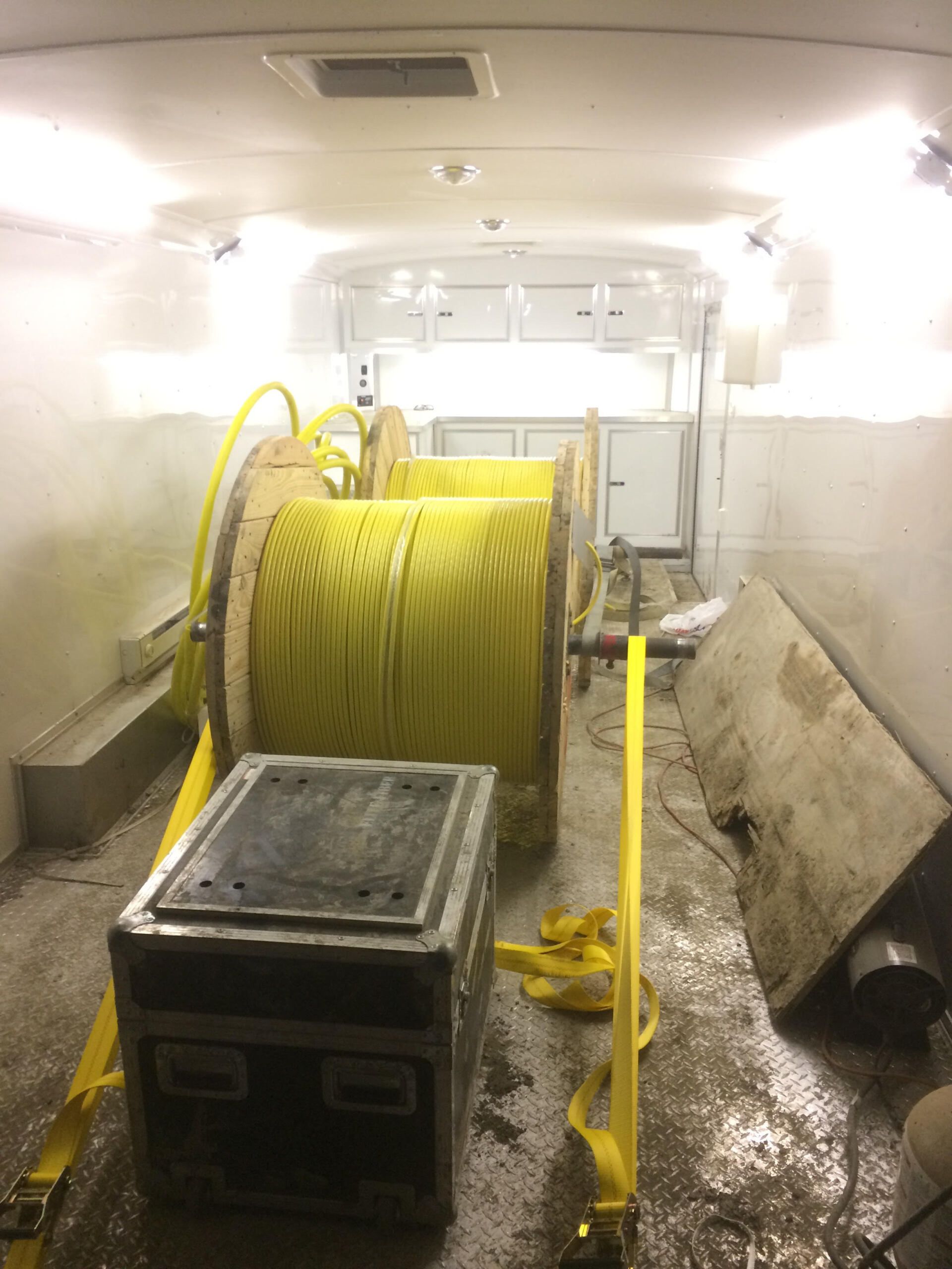 A bunch of spools of yellow wires in a room