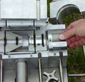 A person is holding a piece of metal in their hand.