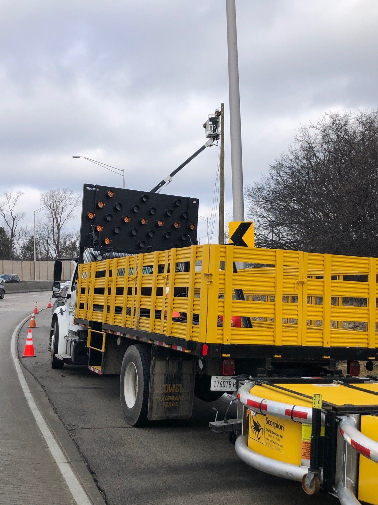 A yellow truck is parked on the side of the road