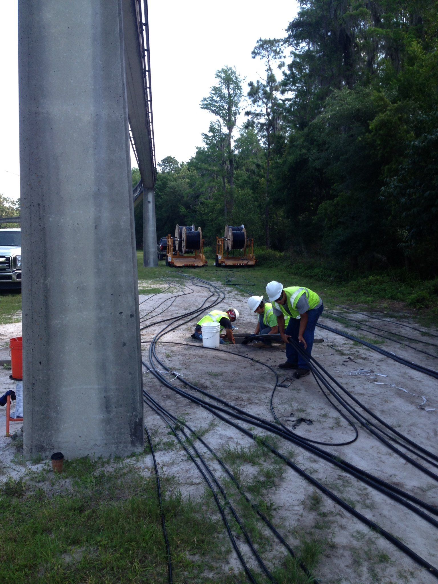 A group of construction workers are working on a power line