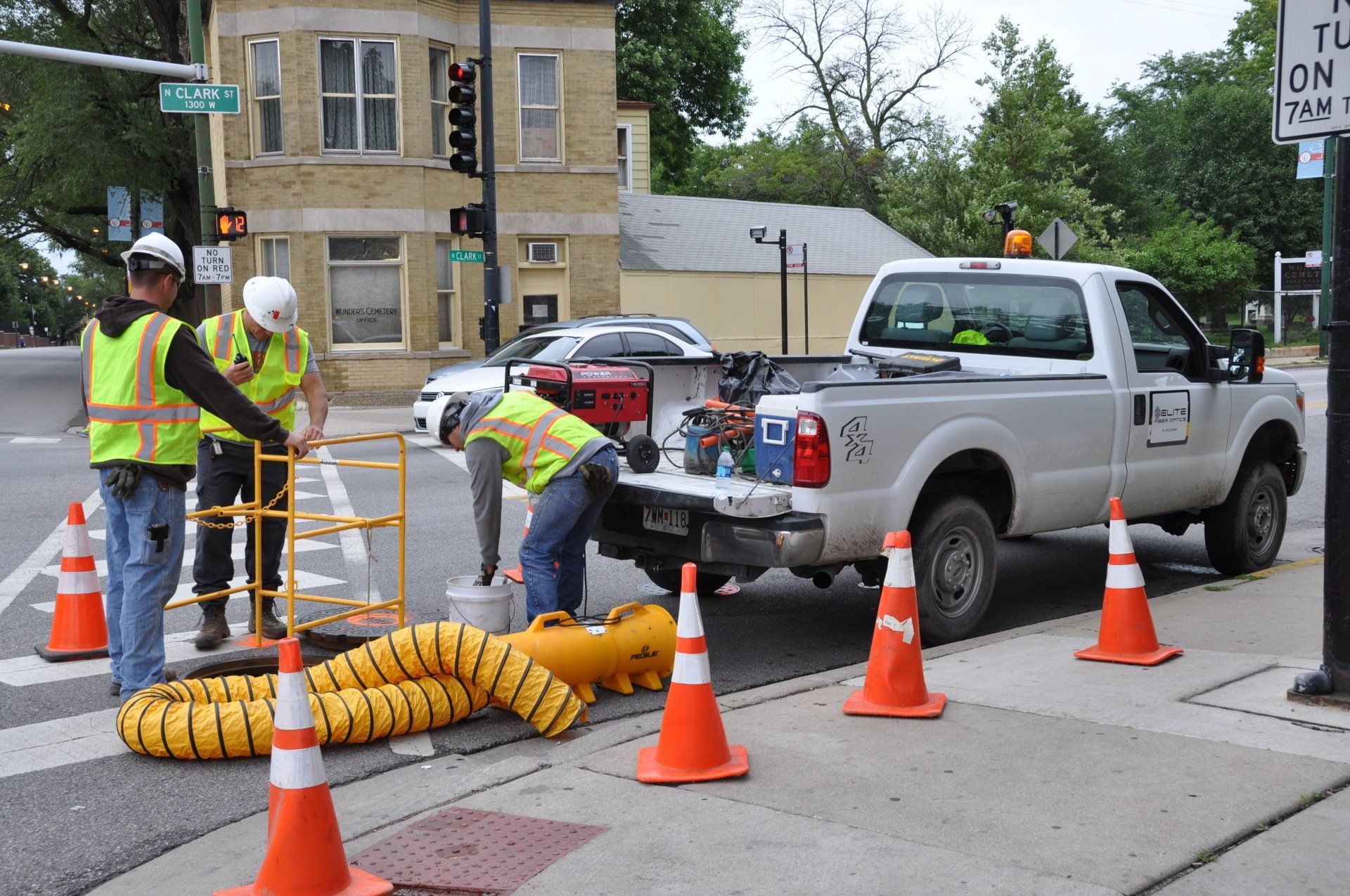 A group of construction workers are working on a street