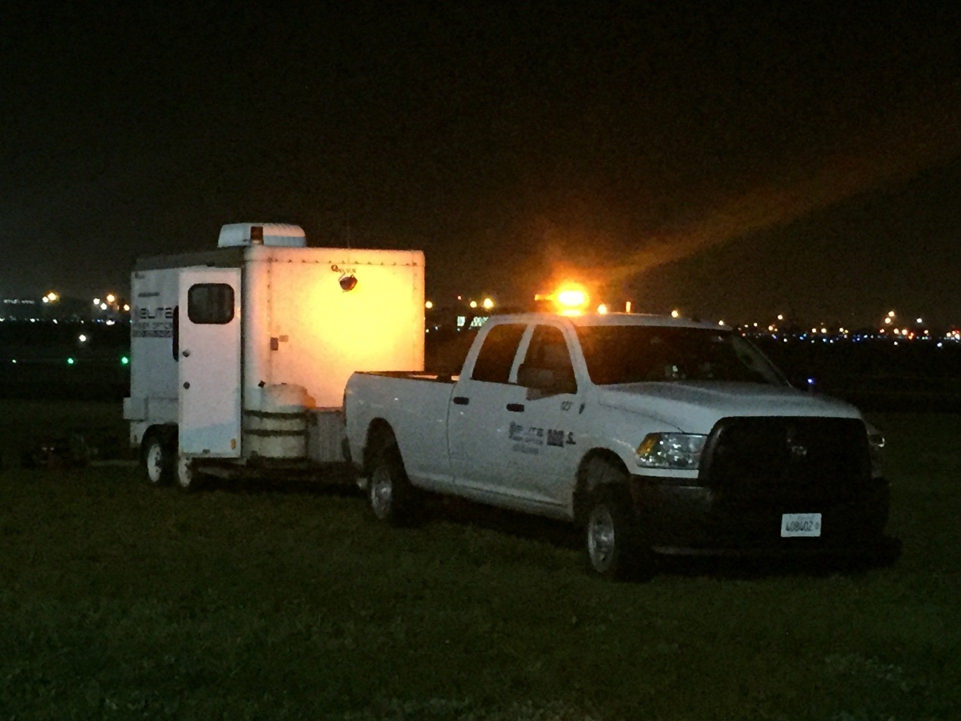 A white truck with a trailer attached to it