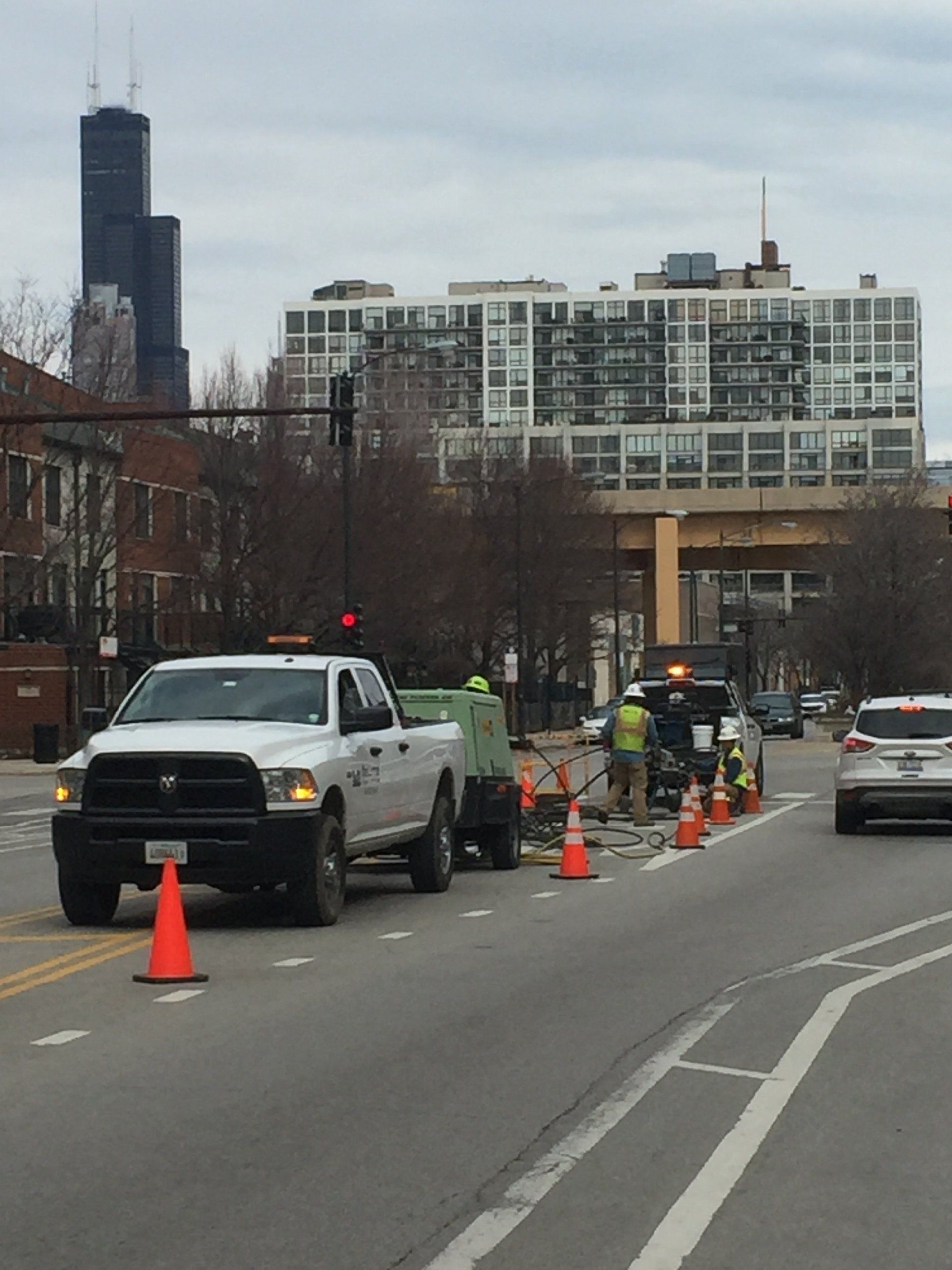 A white truck is parked on the side of the road