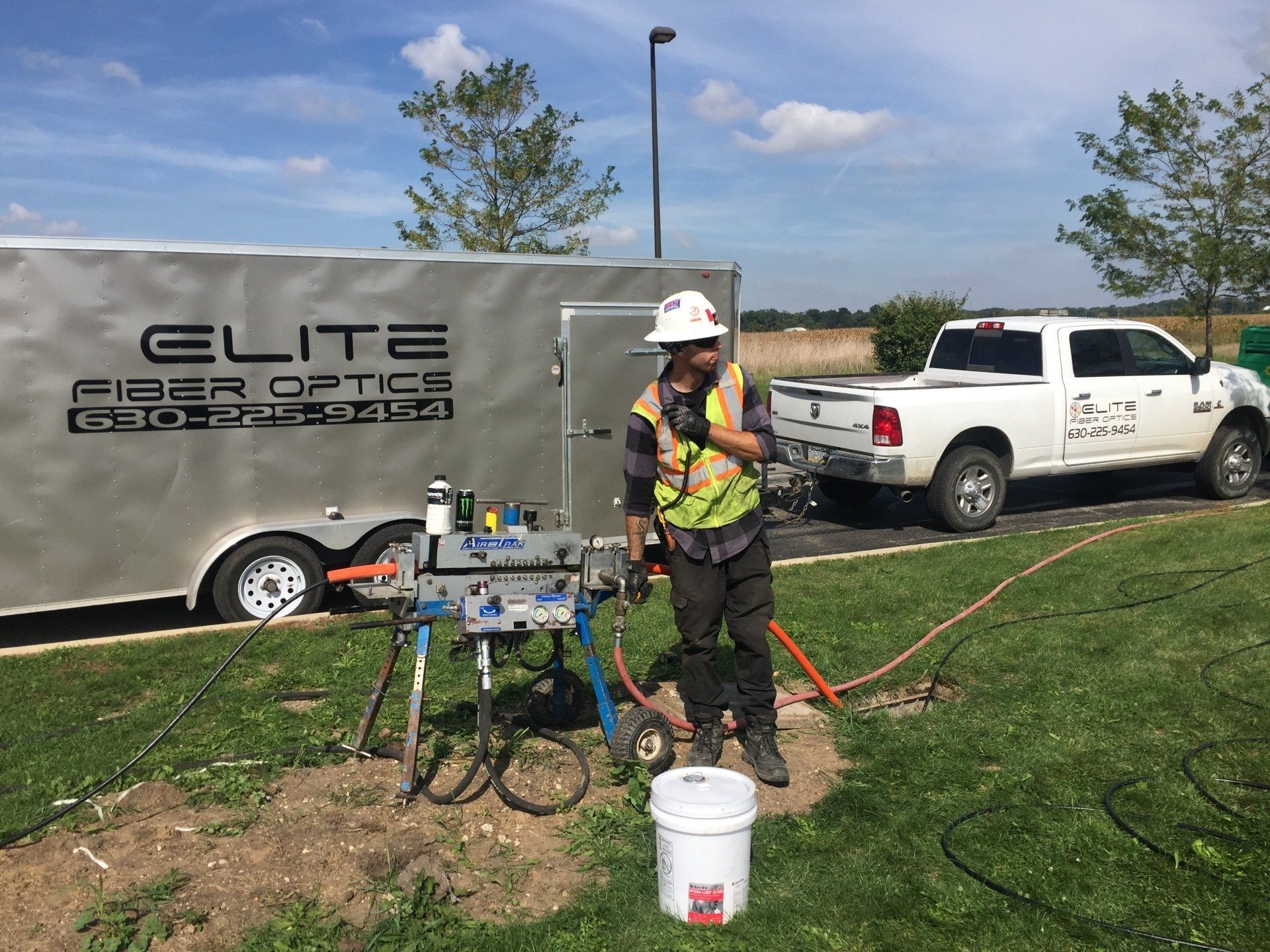 A man is standing in front of a trailer that says elite fiber of ice.