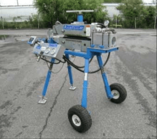 A blue and silver machine with wheels is sitting on the ground