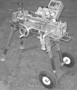 A black and white photo of a machine with wheels