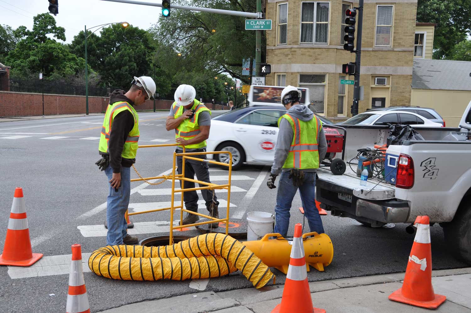 A group of construction workers are working on a street