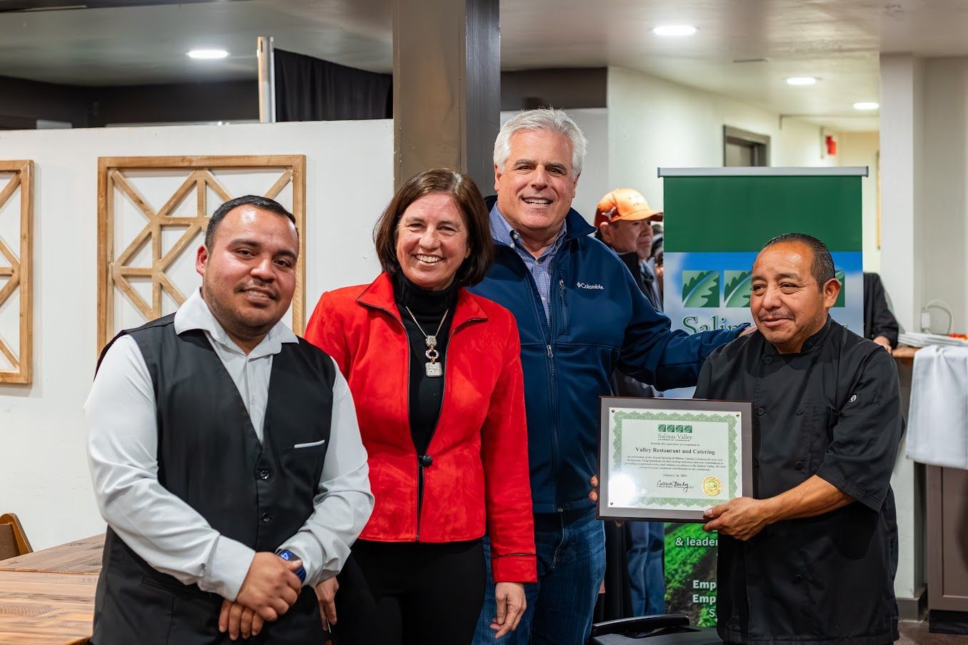 A group of people standing next to each other holding a certificate.