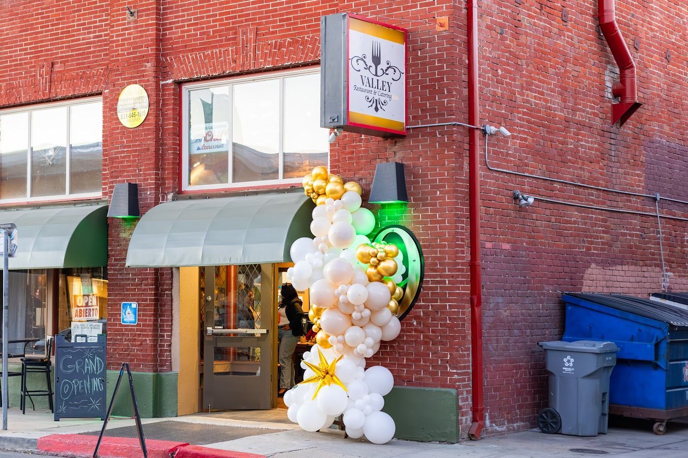 A brick building with balloons in front of it.