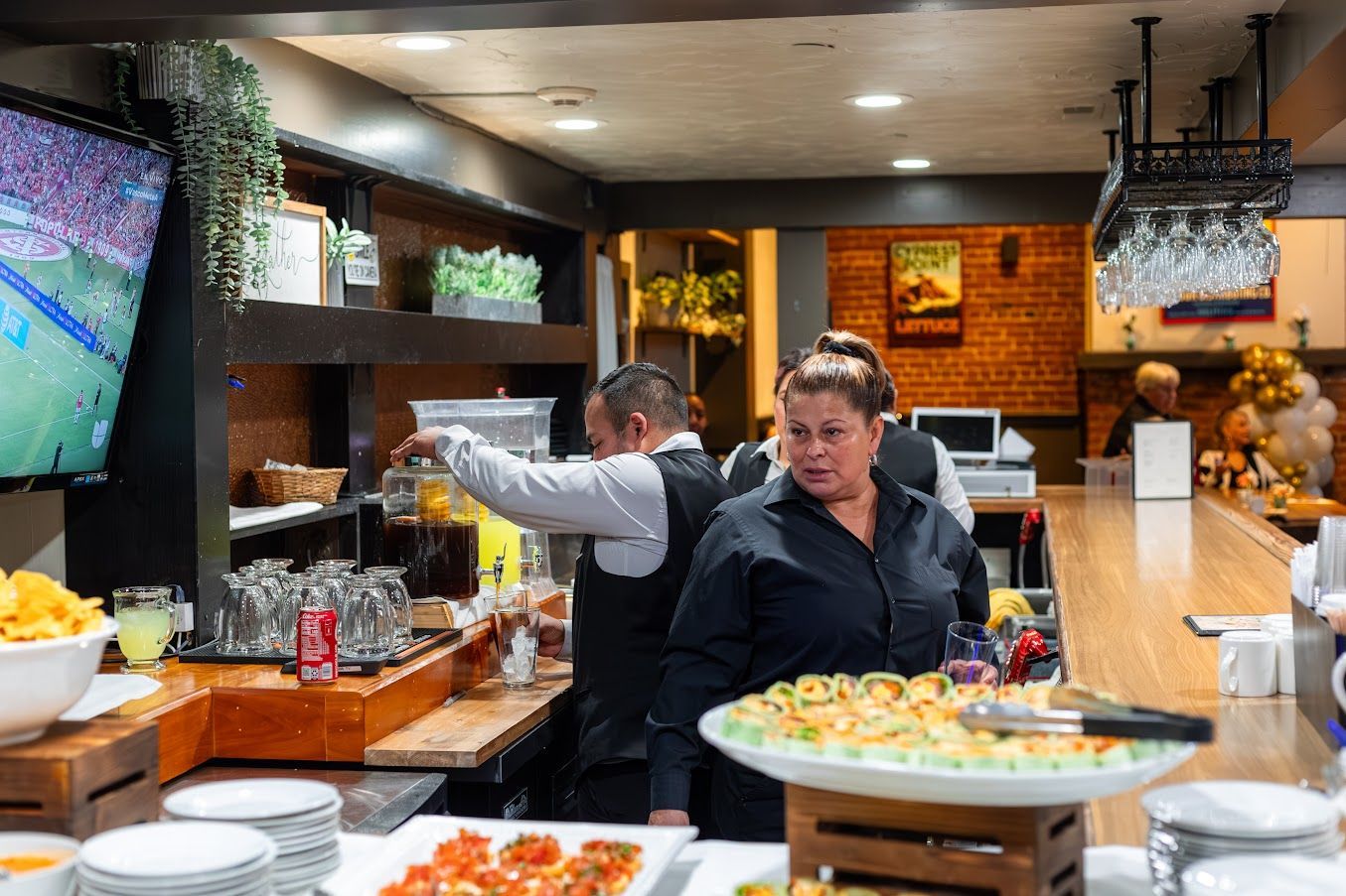 A group of people are preparing food in a restaurant.