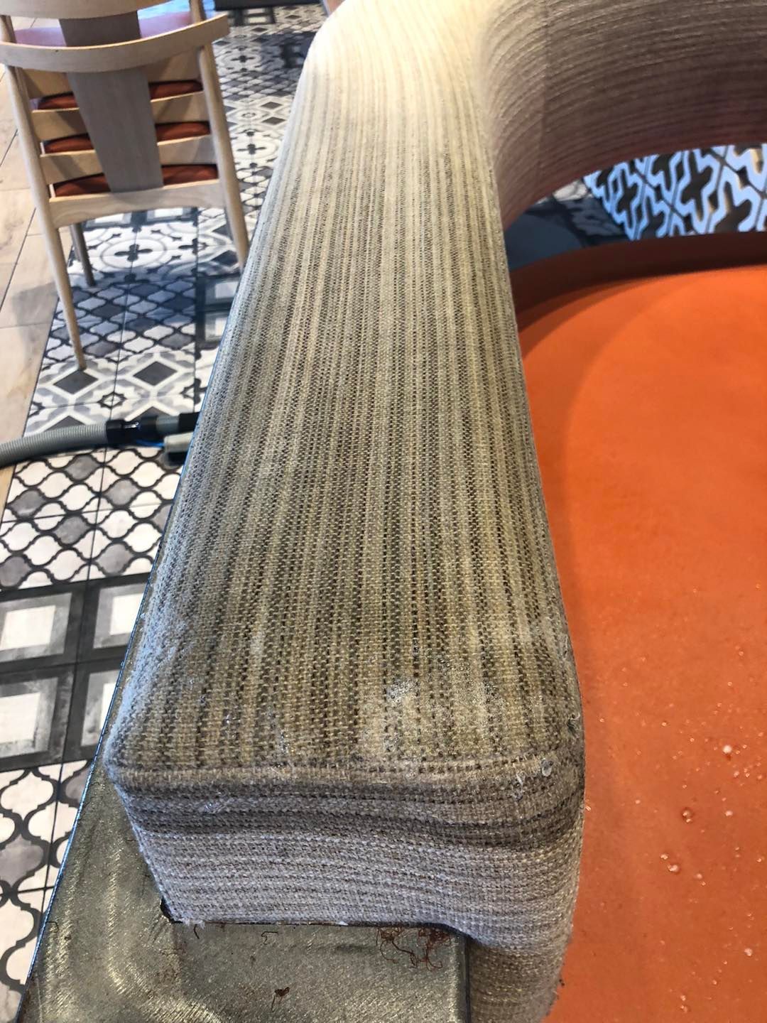A close up of the arm of a chair in a restaurant.