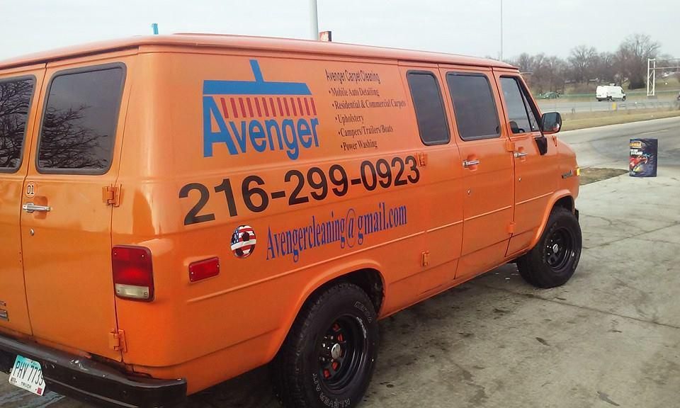 An orange van with avenger written on the side