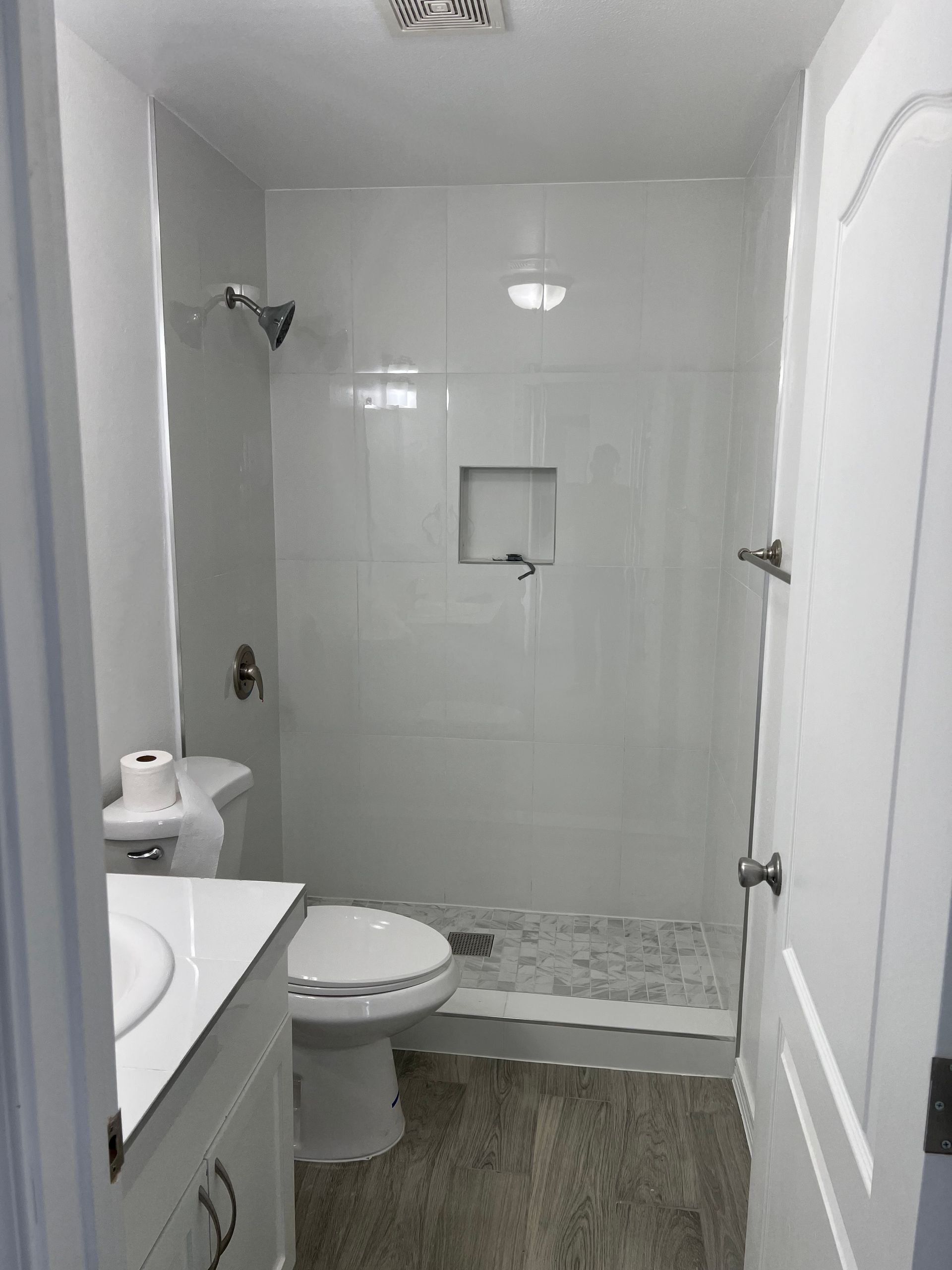 A bathroom with a toilet , sink , and shower.