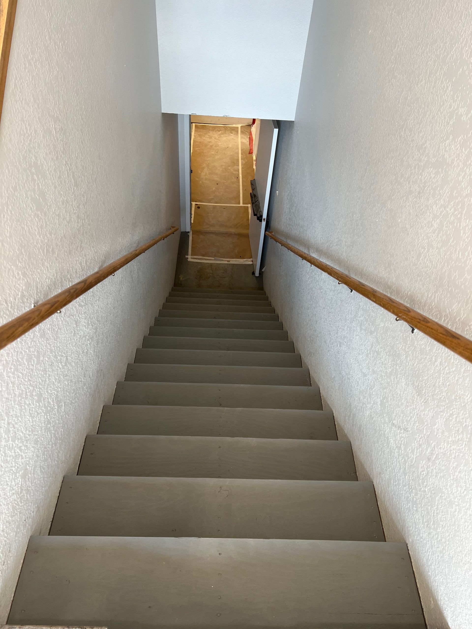 A set of stairs leading up to a door in a building.