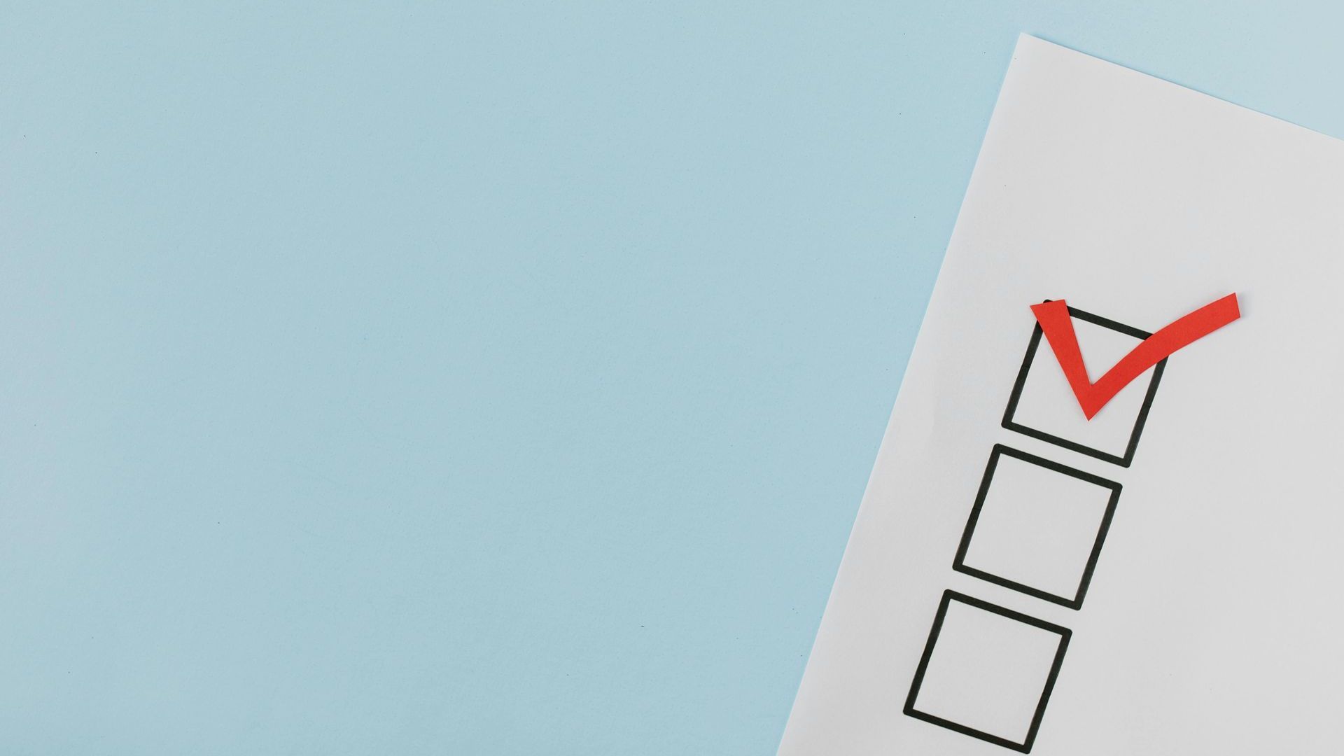 A checklist with a red check mark on a blue background.