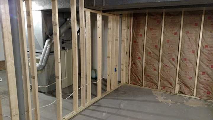 A basement is being built with wooden beams and insulation.