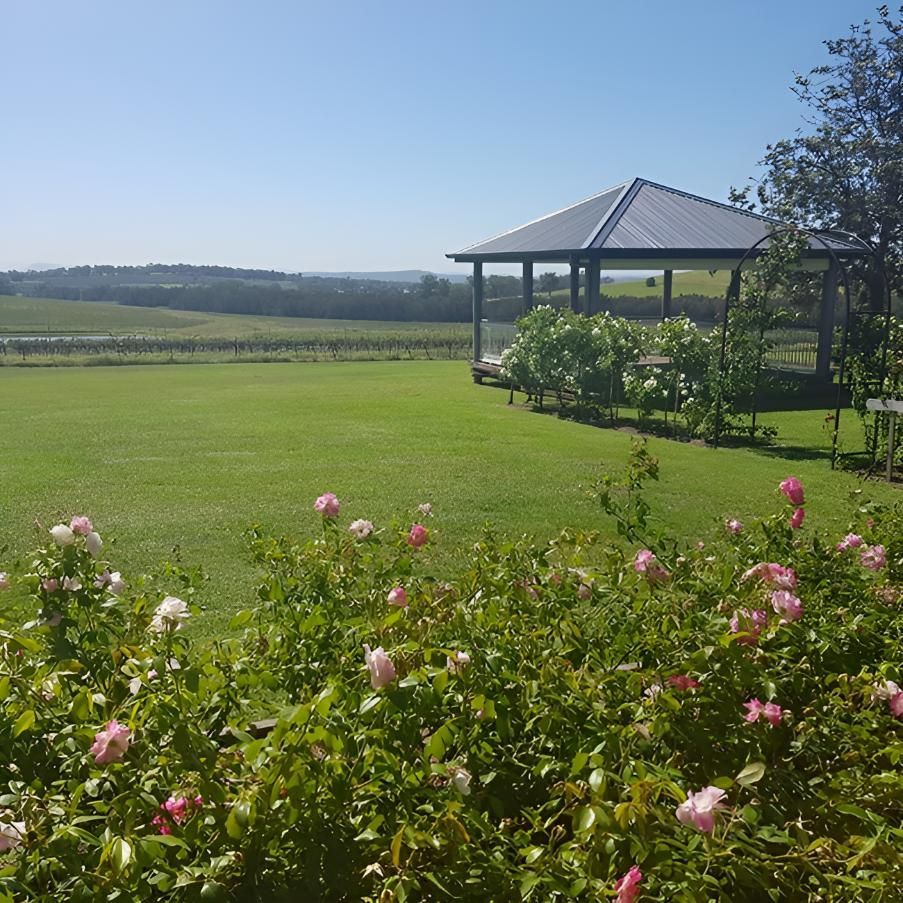 A Gazebo In The Middle Of A Lush Green Field — The Local Bloke Lawn & Garden Care In Warners Bay, NSW