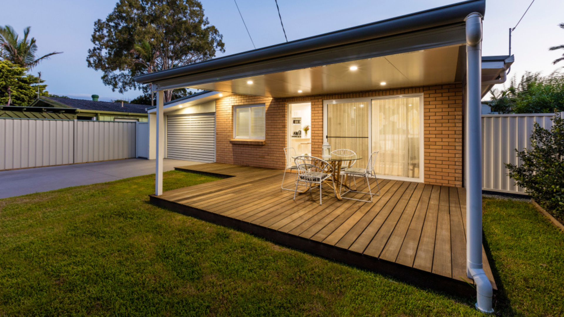 A Large Grassy Field With A Fence And Trees In The Background — The Local Bloke Lawn & Garden Care In Warners Bay, NSW