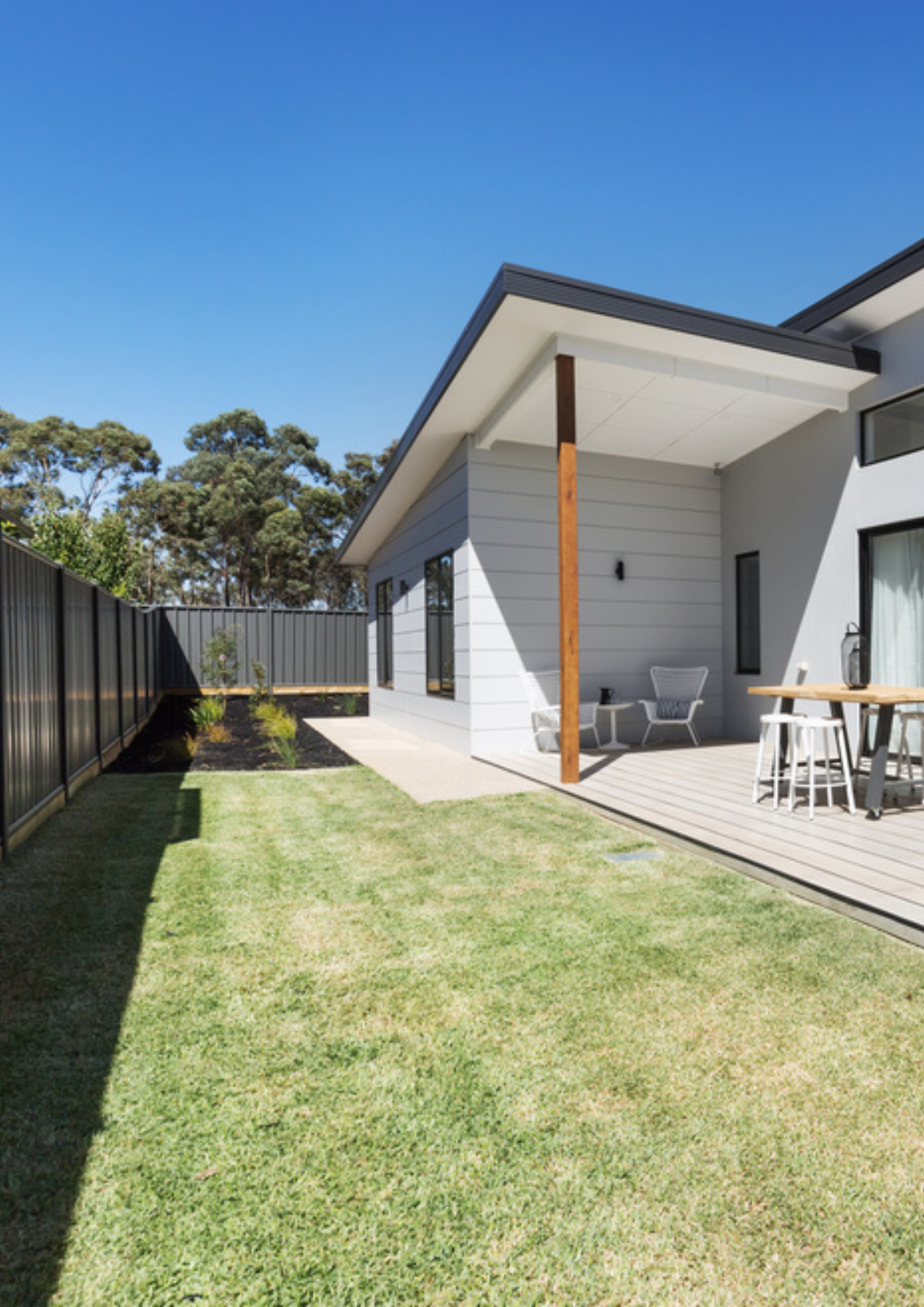 Two Lawn Mowers Are Parked In A Lush Green Yard — The Local Bloke Lawn & Garden Care In Warners Bay, NSW