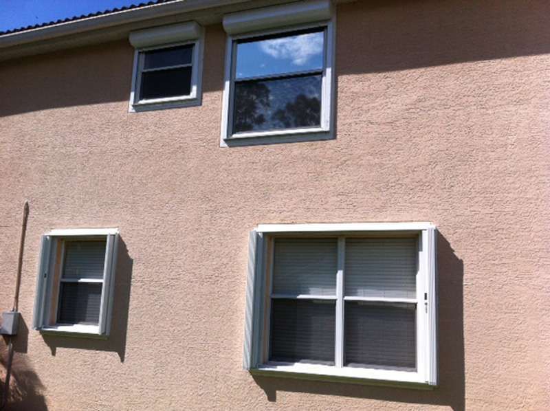 A House With Three Windows on the Side of It — Naples, FL — Wind Safe Shutters LLC