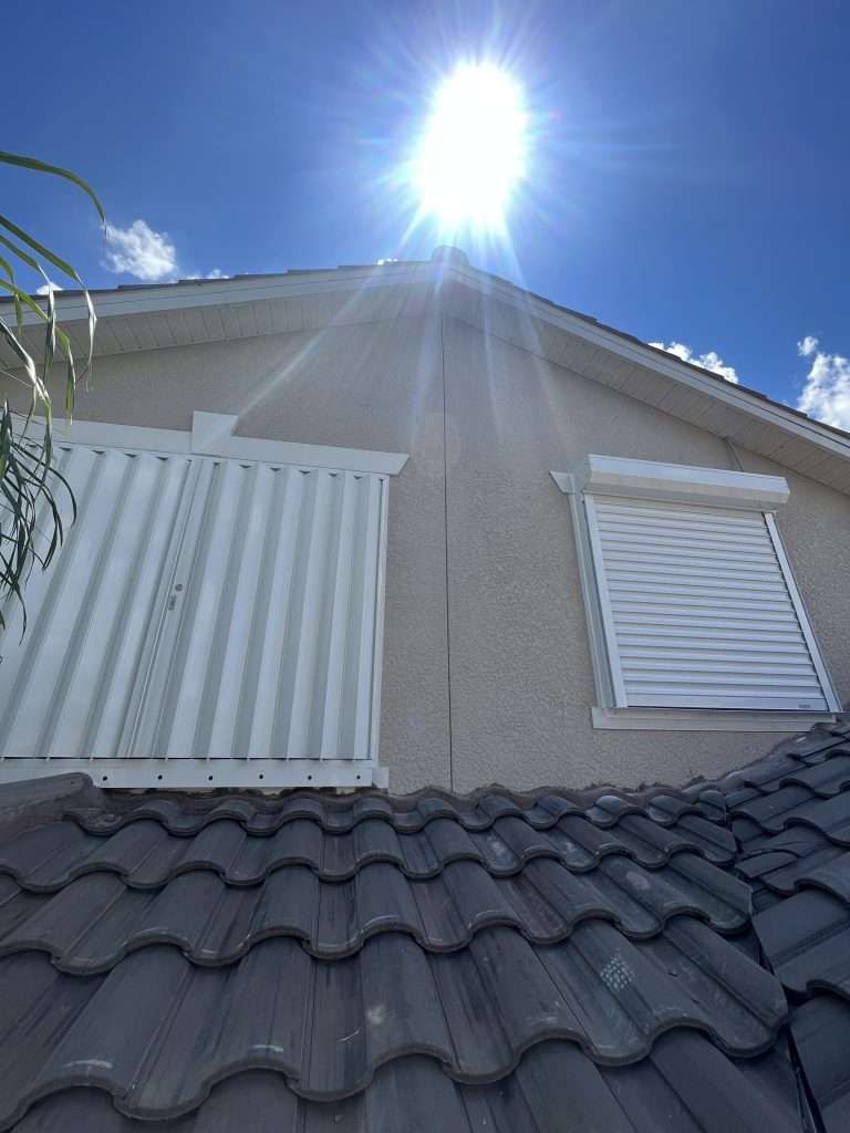 The Sun Is Shining Through the Windows of a House — Naples, FL — Wind Safe Shutters LLC
