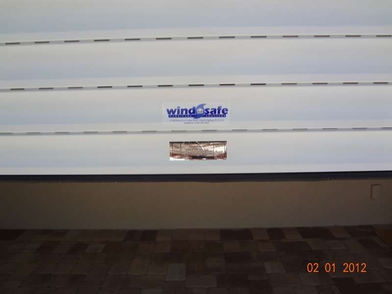 A White Door With the Word Windsafe on It — Naples, FL — Wind Safe Shutters LLC