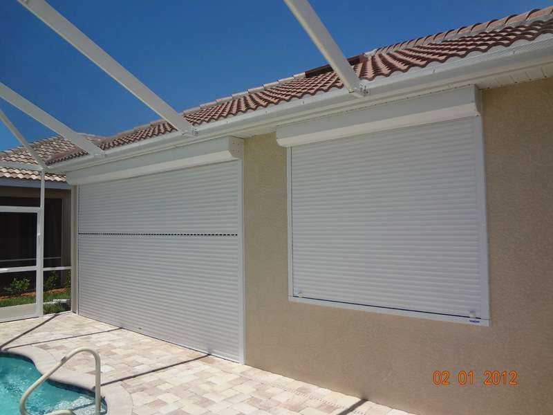 A House With a Swimming Pool and Shutters on the Windows — Naples, FL — Wind Safe Shutters LLC