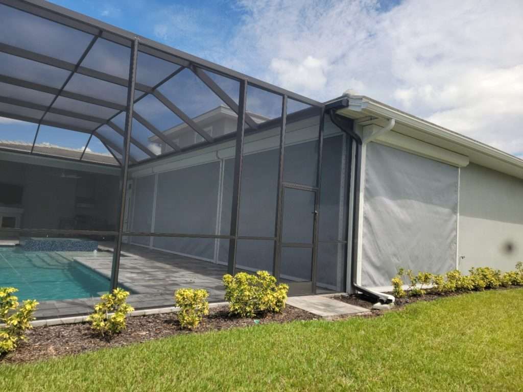 A Screened in Swimming Pool With a House in the Background — Naples, FL — Wind Safe Shutters LLC