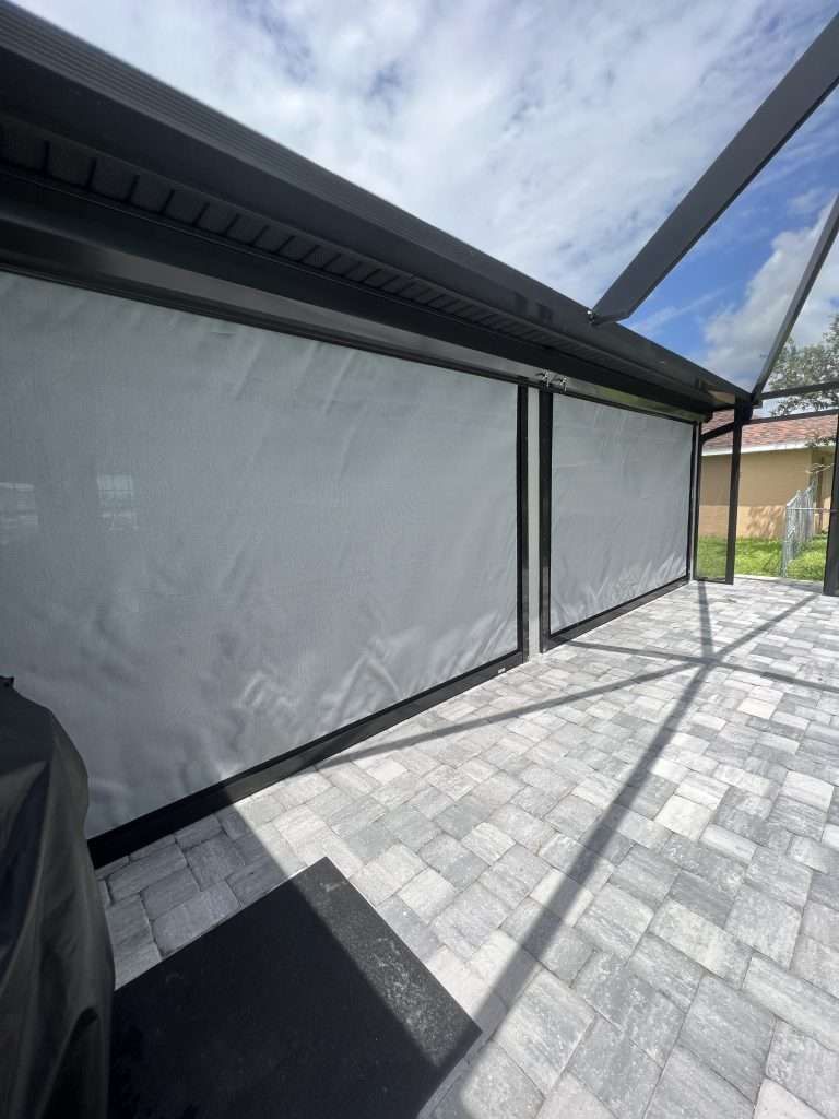 A Patio With a Screened in Porch and a Grill — Naples, FL — Wind Safe Shutters LLC