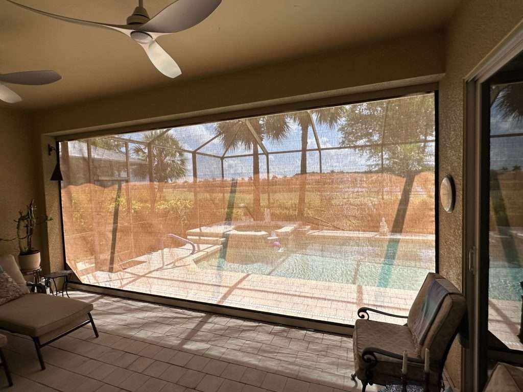 A Screened in Porch With a View of a Swimming Pool — Naples, FL — Wind Safe Shutters LLC
