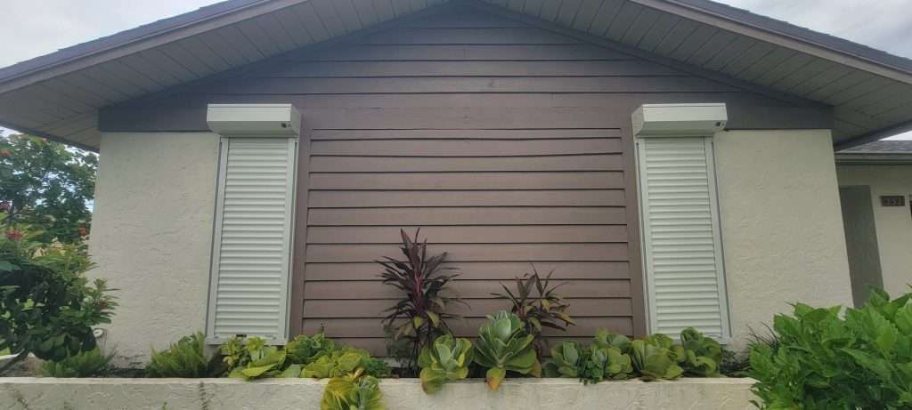 The Front of a House With Shutters on the Windows — Naples, FL — Wind Safe Shutters LLC