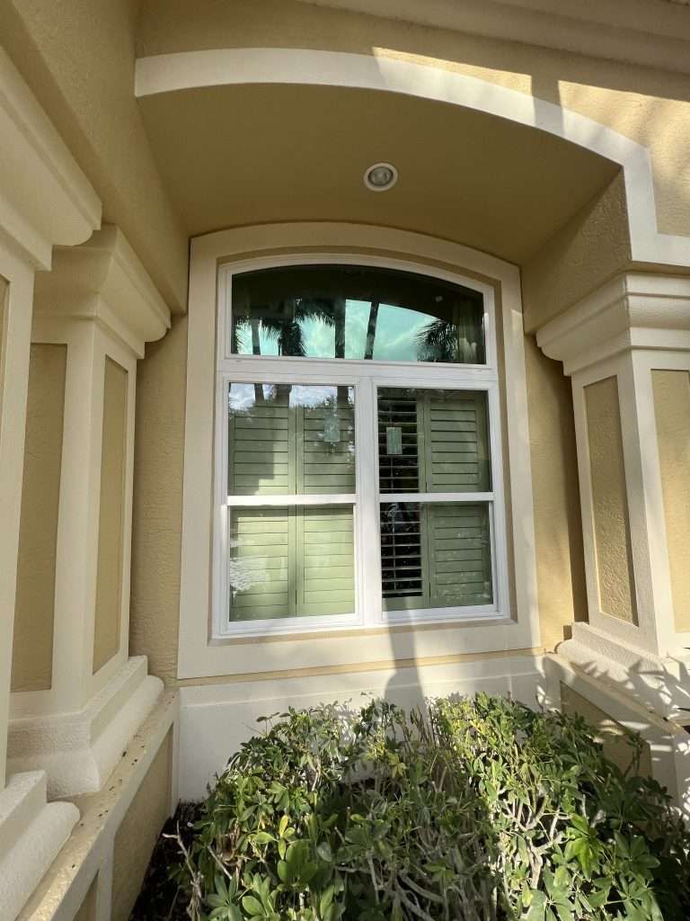 A Large Window on the Side of a Building — Naples, FL — Wind Safe Shutters LLC