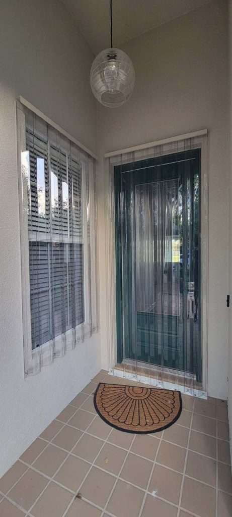 A Porch With a Door, Window, and Rug — Naples, FL — Wind Safe Shutters LLC