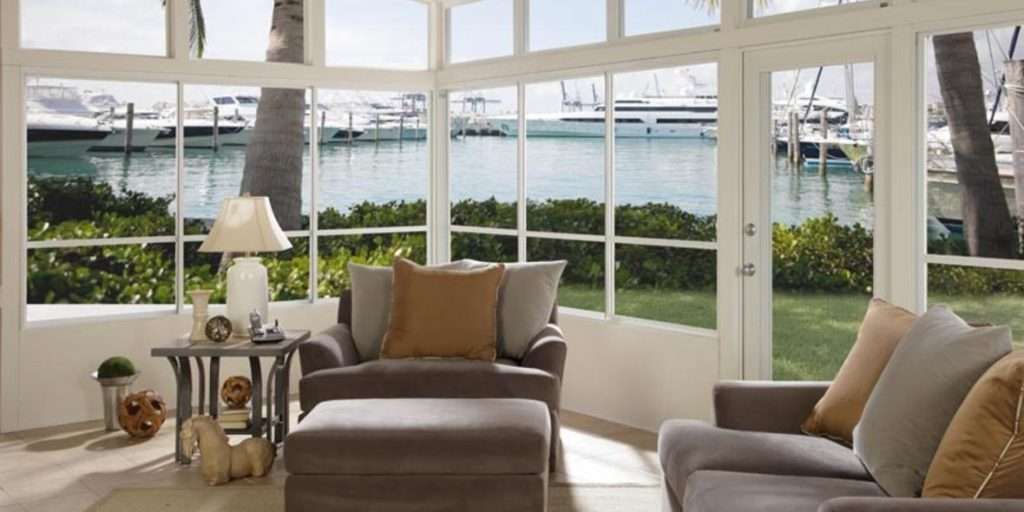 A Living Room With a View of a Body of Water — Naples, FL — Wind Safe Shutters LLC