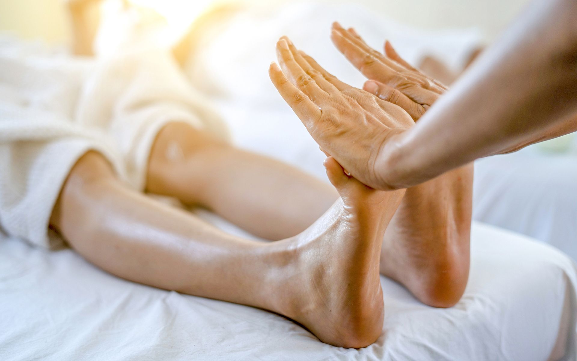 A woman is getting a foot massage in a spa.