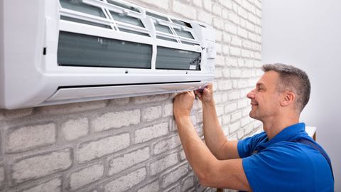 Man Installing AC — Naples, FL — Family Air Conditioning and Heating