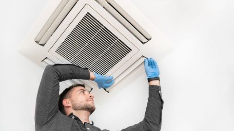 Technician Checking AC — Naples, FL — Family Air Conditioning and Heating