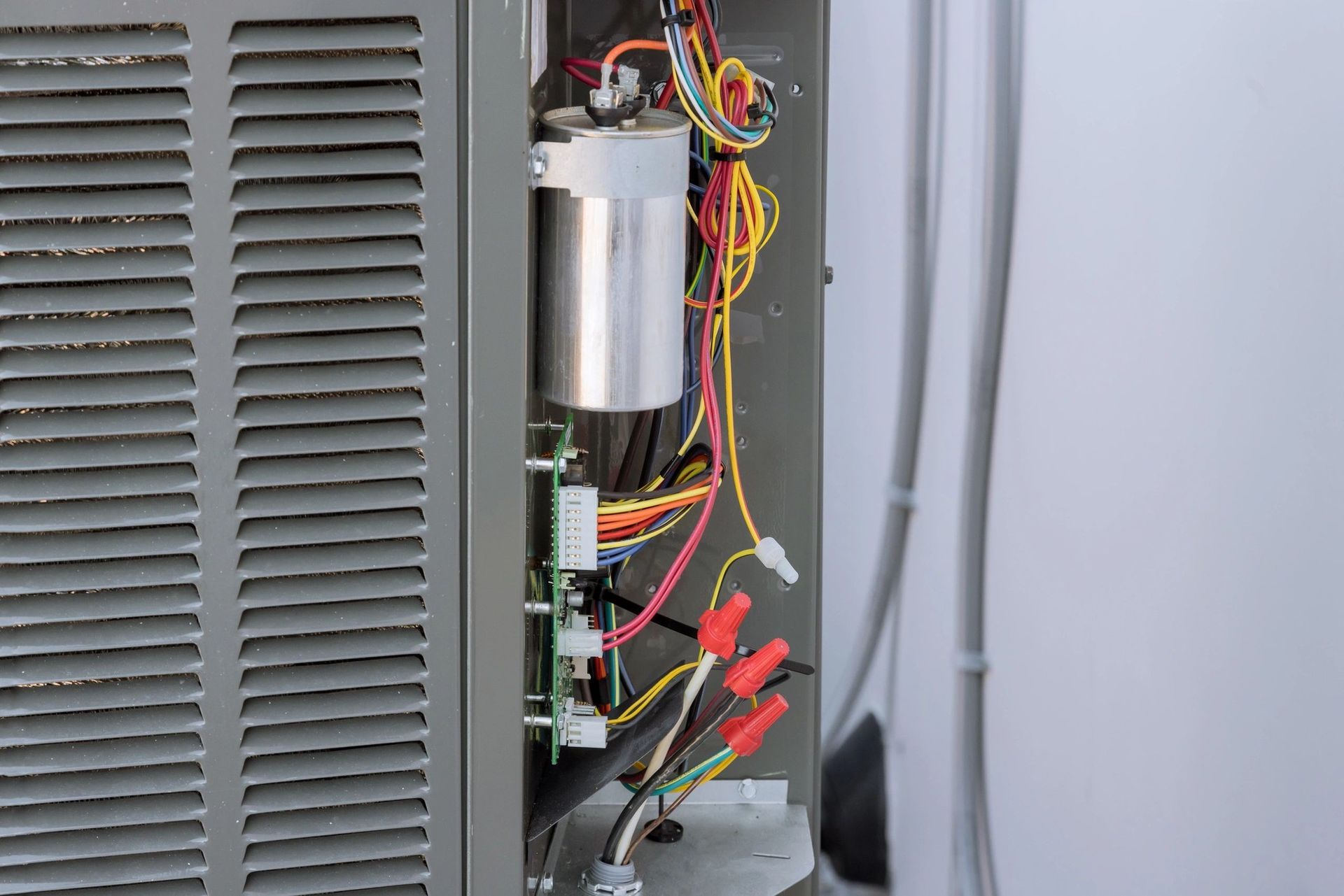 A man in a plaid shirt is using a laptop