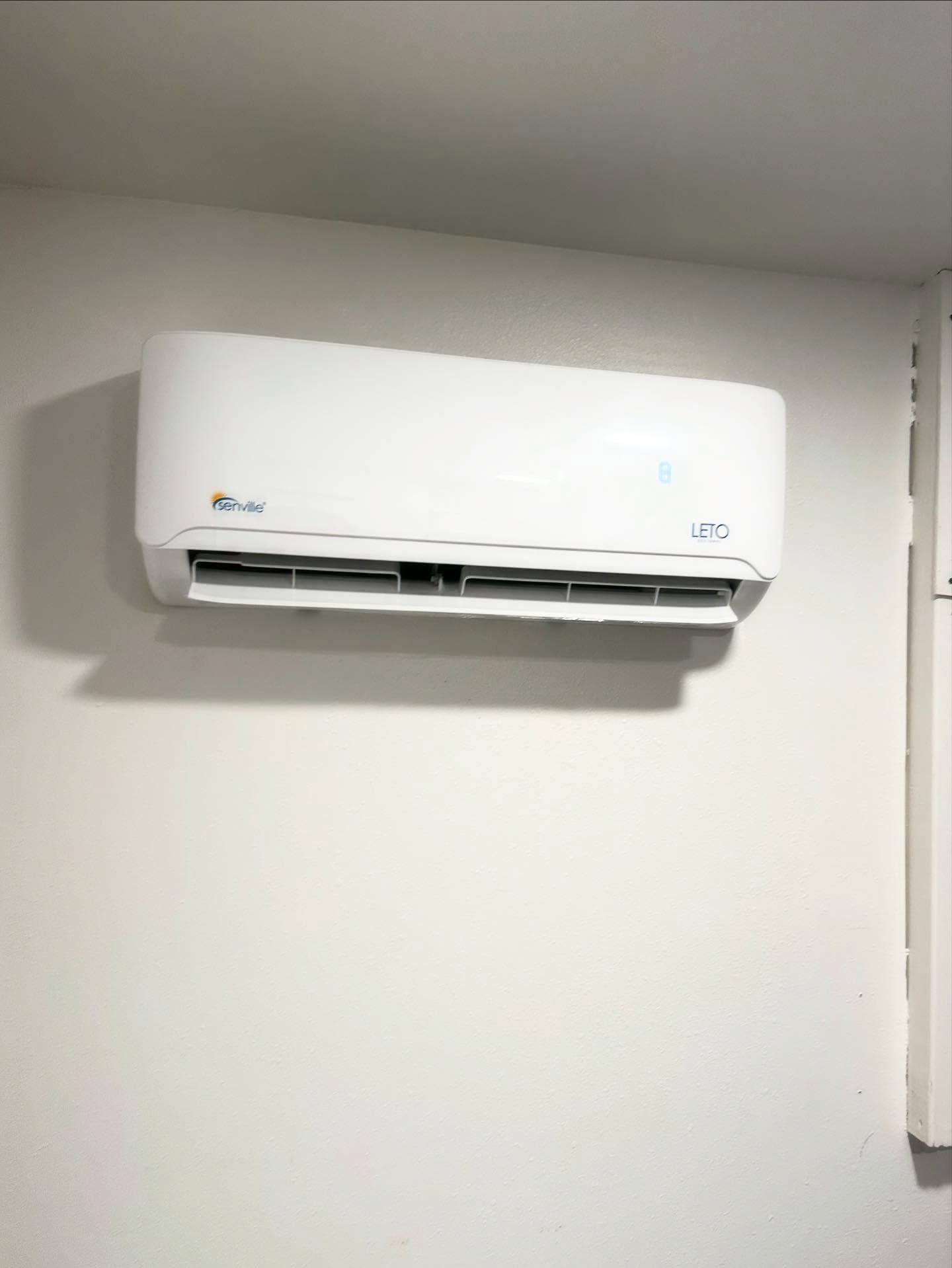 White wall-mounted air conditioner unit.