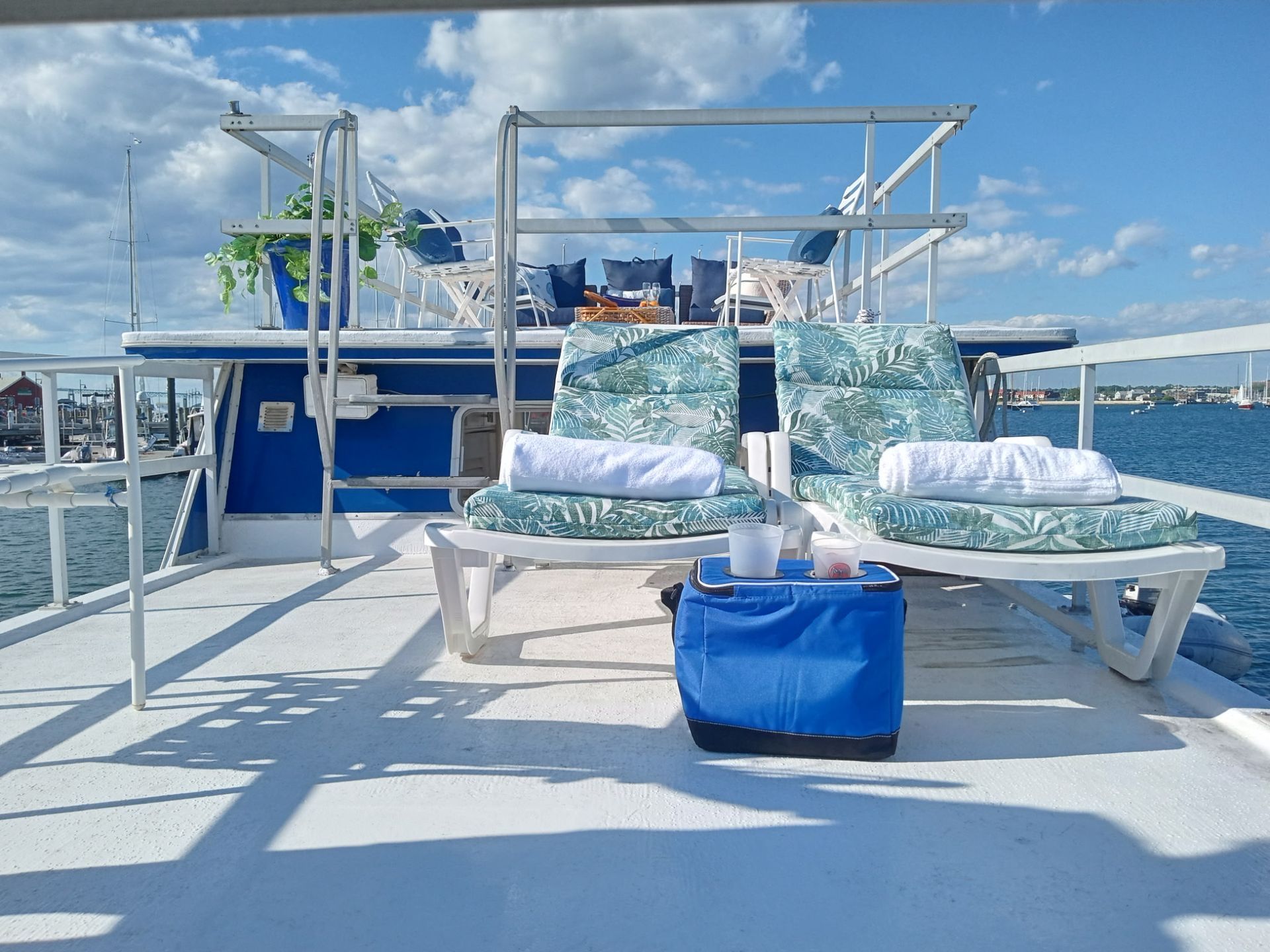Deck seating and towels aboard the houseboat, moored in Newport Harbor