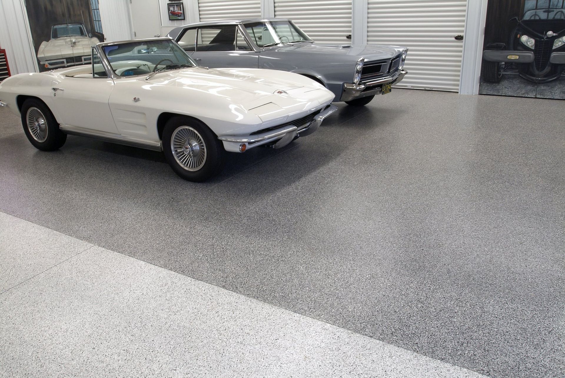 A large auto shop with a gray floor epoxy flooring and white walls.