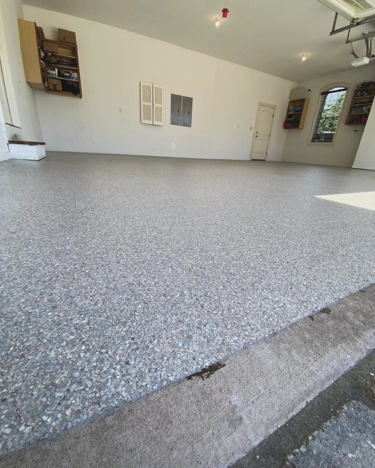 A garage with a gray floor and white walls
