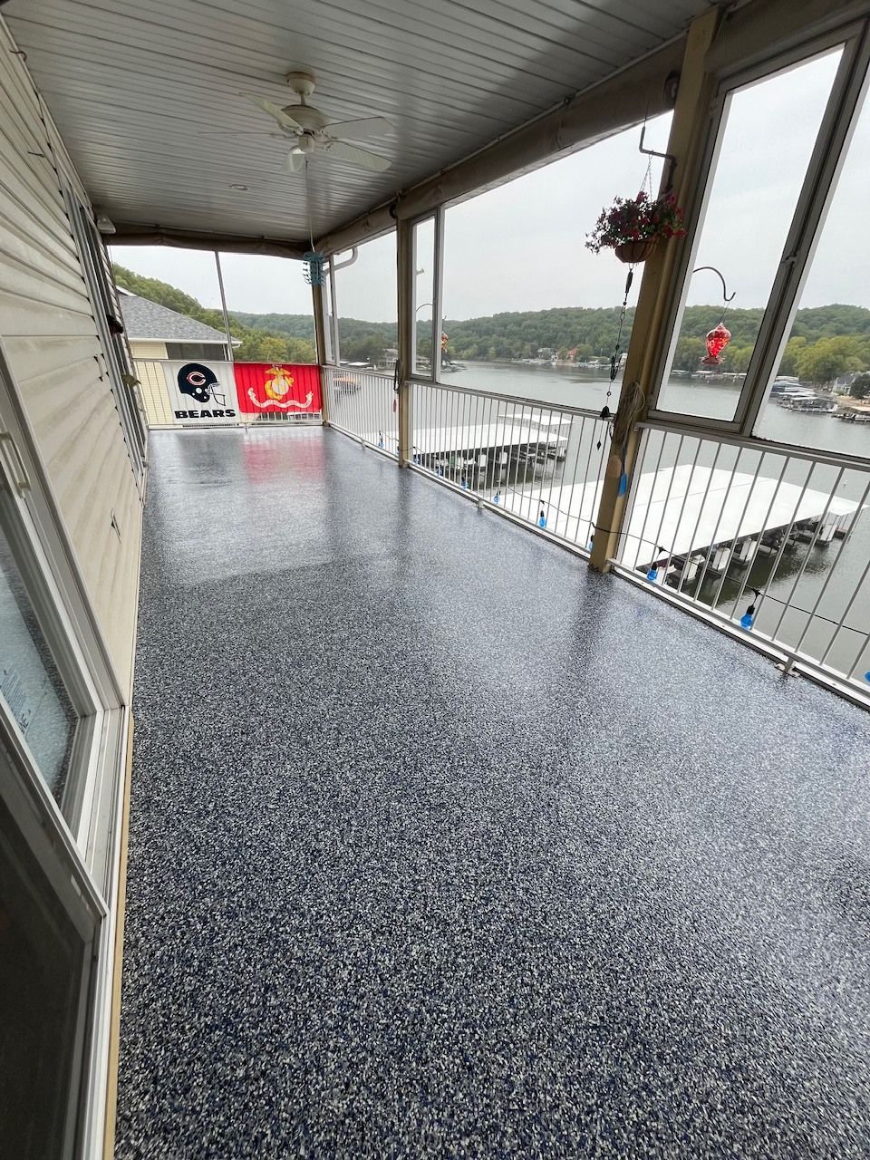 A large porch with a view of a lake.