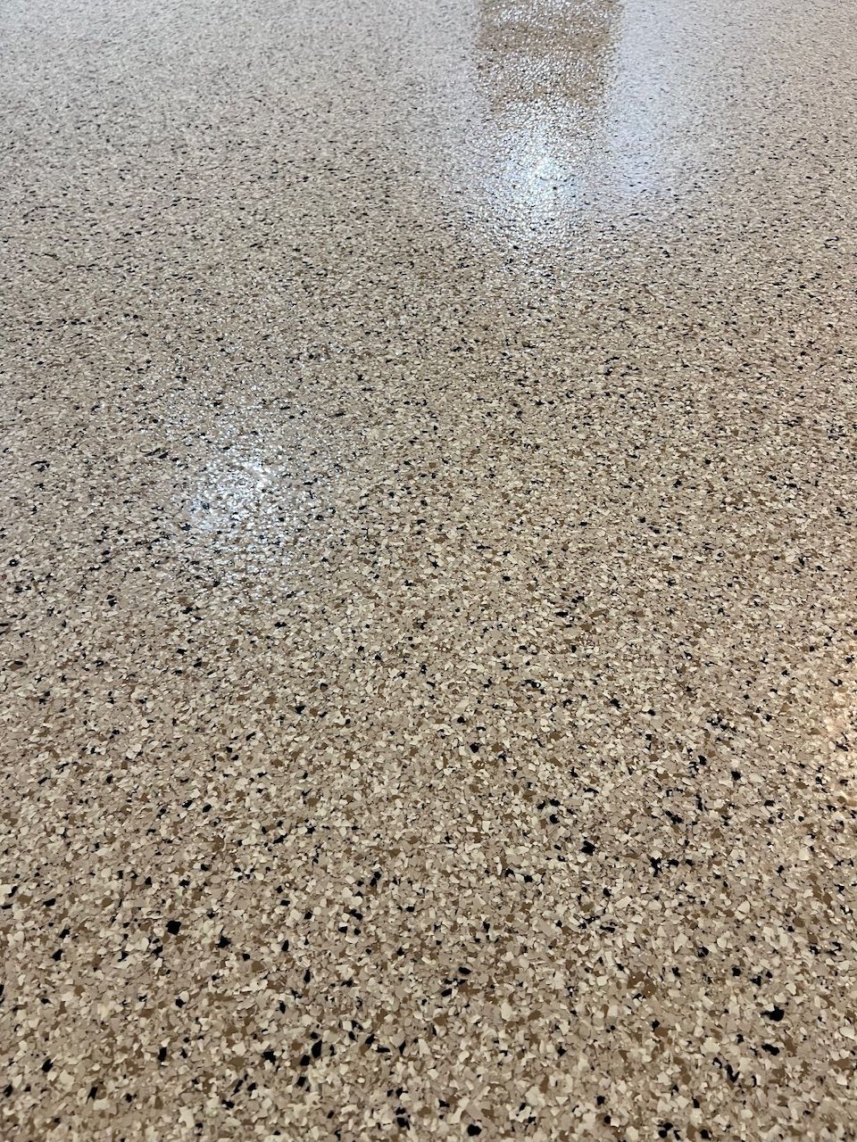 A close up of a floor with a lot of small stones on it.