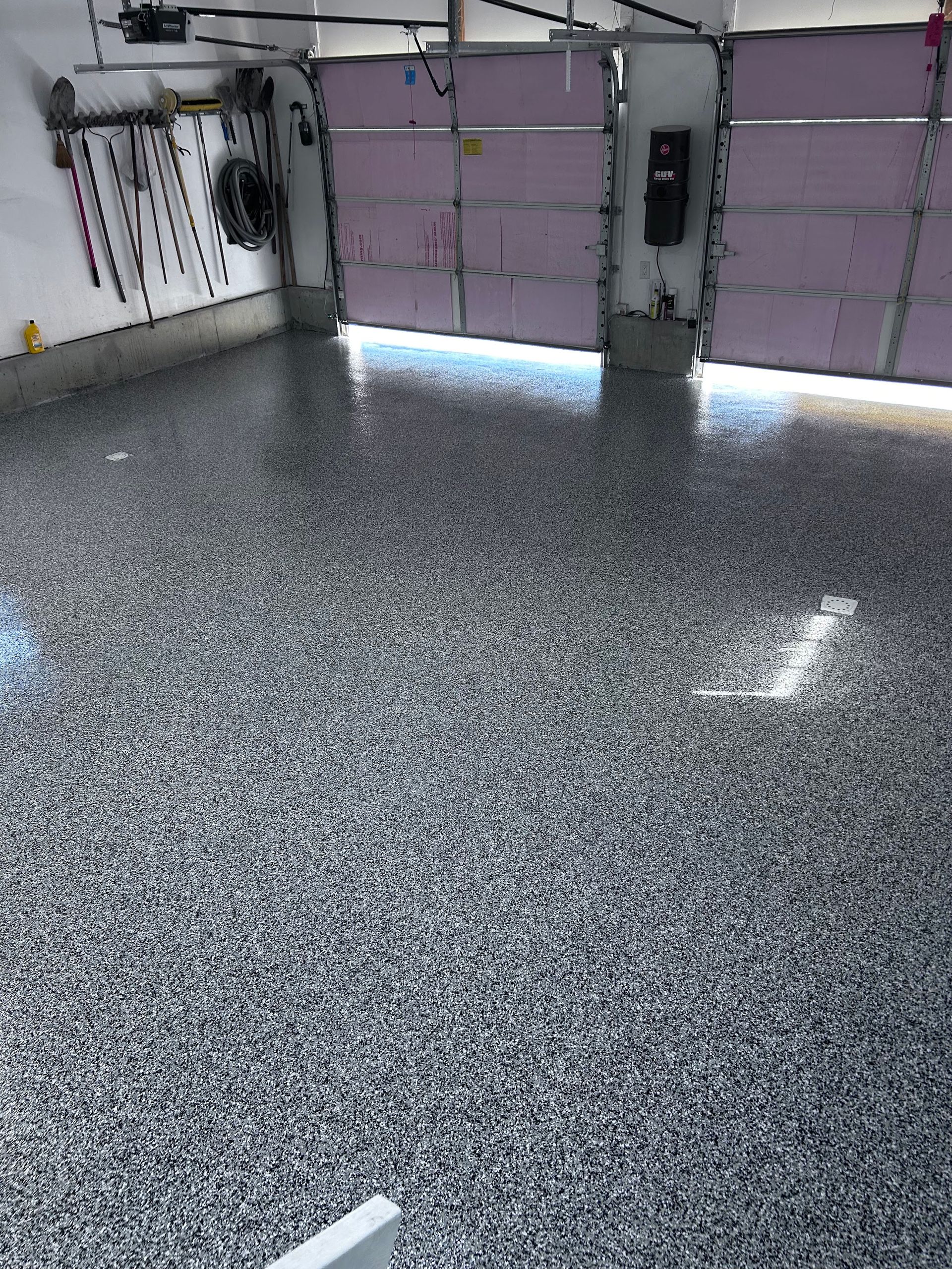 A garage with a gray floor and a purple garage door.